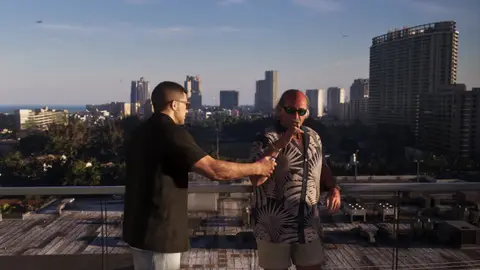 Brian Heder shaking hands with Jason on the Effluvia rooftop, from the GTA 6 Extended Look
