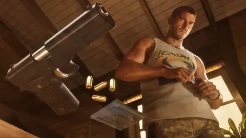 A chrome pistol and loose rounds in the foreground with Jason loading a magazine in a Keys house