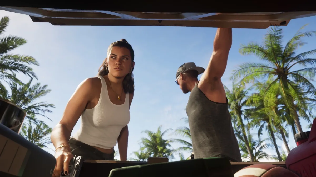 Official GTA VI Trailer 2 screenshot of Jason and Lucia at an open car trunk, Lucia holding a pistol, palm trees behind them